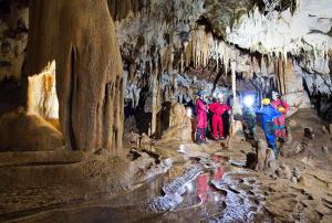 a group of people standing in a cave at Apartamentos El Castañeu in Corao
