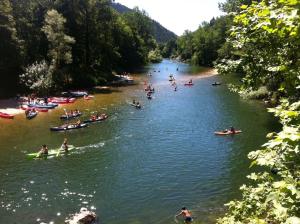 a group of people in boats on a river at Apartamentos El Castañeu in Corao