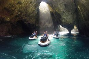 a group of people riding on rafts in a cave at Apartamentos El Castañeu in Corao