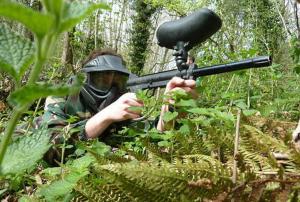 a man wearing a gas mask holding a gun in the woods at Apartamentos El Castañeu in Corao