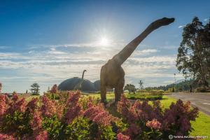 a statue of a giraffe in a field of flowers at Apartamentos El Castañeu in Corao