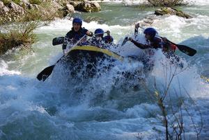 a group of people on a raft in a river at Apartamentos El Castañeu in Corao