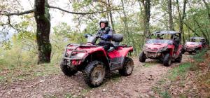 two atvs and a man riding on a dirt trail at Apartamentos El Castañeu in Corao