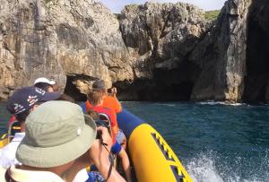 a group of people on a raft going through a cave at Apartamentos El Castañeu in Corao