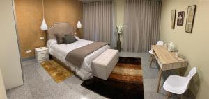 um quarto de hotel com uma cama e uma secretária e uma mesa e cadeira em Apartamento "CAMPO CARMEN" nas Tordesilhas