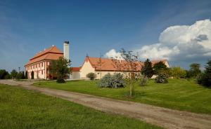 a large house with a grass yard next to a road at Residence Safari Resort - Chateau in Borovany