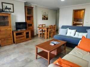 a living room with a couch and a table at Apartamentos Deluxe San Julian in Torrevieja