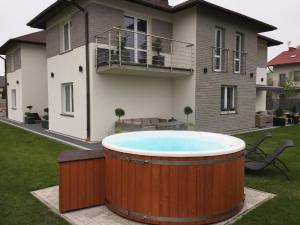 a hot tub in the yard of a house at Sunrise Apartaments in Rowy