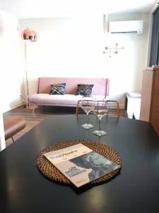 a table with two wine glasses and a book on it at Le Juliette in Lyon