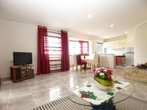 a living room with a table with flowers on it at Apartments Dragica 1251 in Fažana