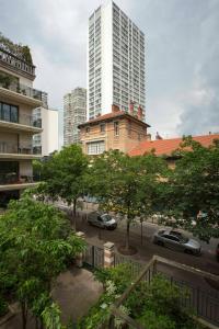 a view of a city with tall buildings and trees at Veeve - Modern Brights in Paris