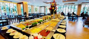 a buffet line of food in a restaurant at Saisawan Beach Luxury Hotel in Na Jomtien