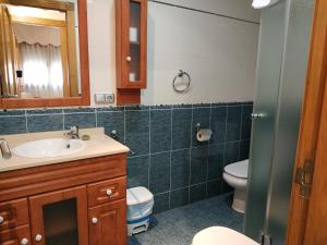 a bathroom with a sink and a toilet at Apartamentos Deluxe San Julian in Torrevieja +69 photos