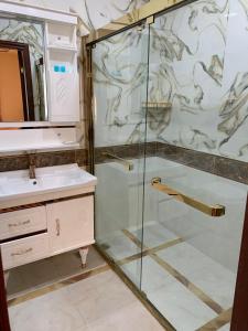 a bathroom with a glass shower and a sink at EL Faro RESORT AND SPA HOTEL in Nabran