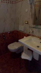 a bathroom with a toilet and a sink at Maxi Heron in Lido di Jesolo
