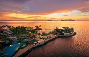 an aerial view of a resort on the water at sunset at Shangri-La Tanjung Aru, Kota Kinabalu in Kota Kinabalu
