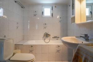 a bathroom with a tub and a toilet and a sink at Paradise residency in Iraklitsa +36 photos