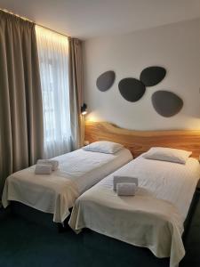 Postel nebo postele na pokoji v ubytování Dunetton - self check-in hotel