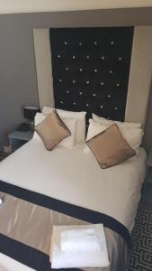 
A bed or beds in a room at The Castle Hotel Neath
