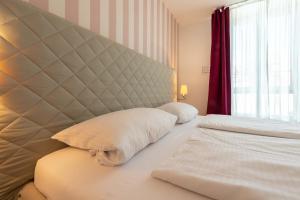 Ein Bett oder Betten in einem Zimmer der Unterkunft Hotel Am Dom
