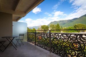 a balcony with a table and chairs and mountains at Lake Home Holiday in Como