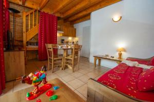 a living room and kitchen with a couch and a table at Résidence Goélia Le Village Gaulois in Saint-François-Longchamp