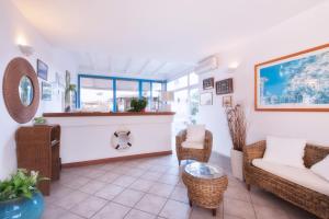 a living room with a couch and chairs at Hotel Mediterraneo in Lido di Latina 