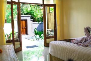 Postel nebo postele na pokoji v ubytování Alam Grigis Ubud