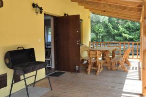 a dining room with a table and a balcony at Domki w Radawie in Radawa