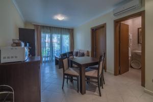 a kitchen and dining room with a table and chairs at Sozopol Private Apartments St. Marina in Sozopol