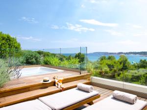 a house with a swimming pool and a deck at Somewhere Vouliagmeni in Athens
