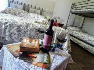 a table with a bottle of wine and a bottle of wine on it at Le Mimose B&B in Vinci