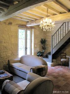 a living room with a couch and a chandelier at Maison Saint-Pé (Gers) in Béraut +43 photos