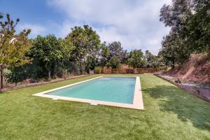 a swimming pool in the middle of a yard at Vivalidays Can Palomo in Palafolls