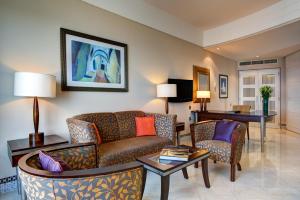a living room with two couches and a table at Corinthia Tripoli in Tripoli