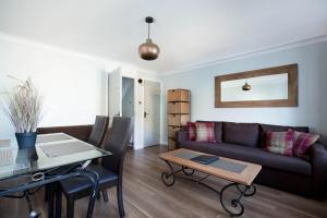 a living room with a couch and a table at Holyrood Skyline Apartment in Edinburgh