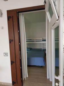 a door leading into a bedroom with a bed at Hotel Perla Gaia in San Vito lo Capo