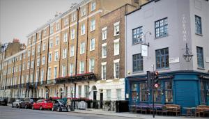 a row of buildings on a city street with a traffic light at The Sumner Hotel in London