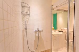 a bathroom with a shower and a sink at The Sumner Hotel in London +99 photos