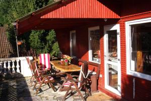 a patio with a table and chairs on a house at Ferienhaus _Am Hexenstieg_ in Rübeland