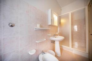a bathroom with a sink and a shower and a toilet at Blue Coral Apartment in Cefalù