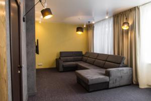
a living room filled with furniture and a couch at New Star Hotel in Perm
