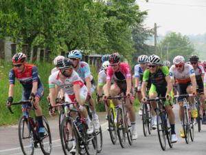 a group of people riding bikes down a road at La Datiniere in Parigny