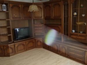 a room with a tv and wooden cabinets at Haus Zauberwald in Reichenbach