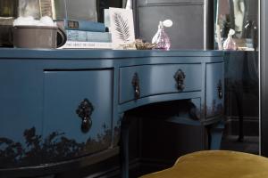 a blue dresser in a room with a table at Luxury Boutique Apt in fashionable Stockbridge 5* in Edinburgh