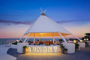 a gazebo with a sign that reads sunset at Paloma Foresta in Beldibi