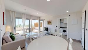 a living room with a couch and a table at Apartment Altos Del Rompido in El Rompido