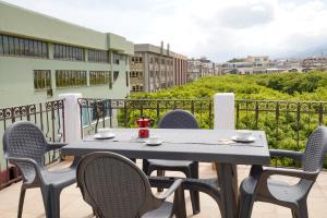 a table and chairs on a balcony with a view at Le Stanze di Piazza Cairoli in Messina
