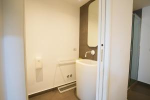 a bathroom with a sink and a mirror at Le Stanze di Piazza Cairoli in Messina