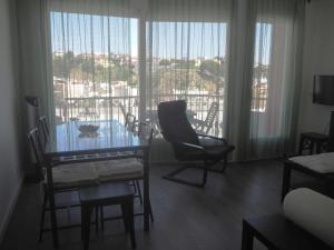 un salon avec une table et des chaises et une fenêtre dans l'établissement APARTAMENTO MAR I CEL, à Blanes
